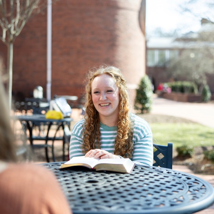 Female Boyce student chatting with friend outside