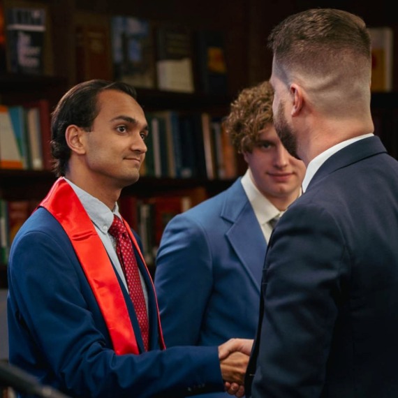 Boyce honors collehium student shaking hands with Dr. Flatt