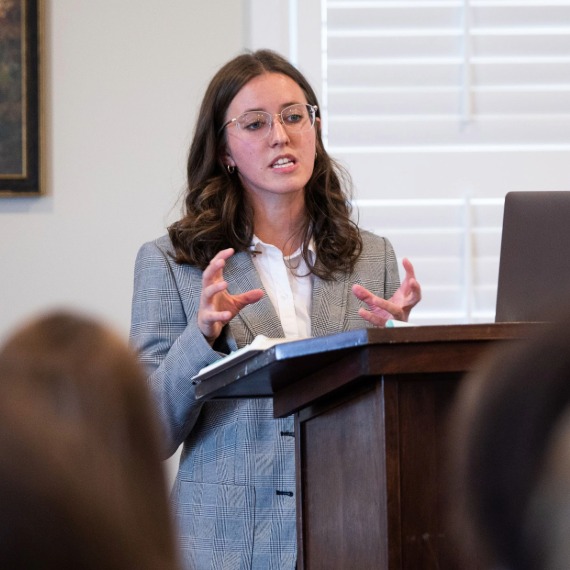 Female student speaking at podium