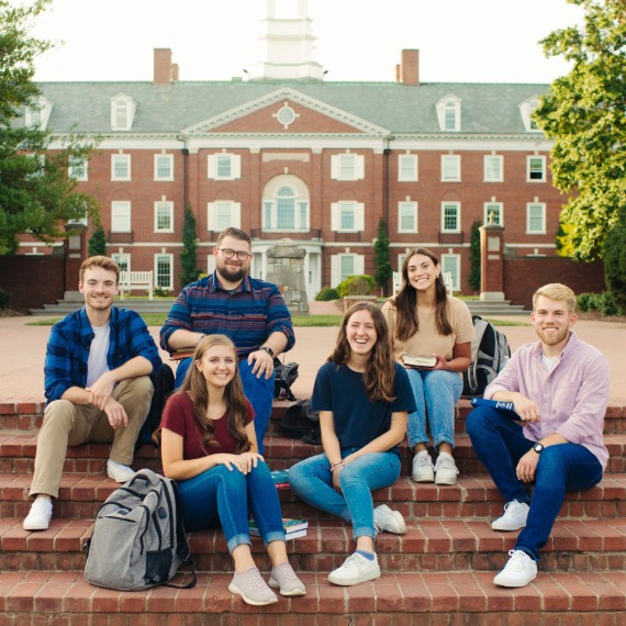 Students sitting on steps in front of Boyce College