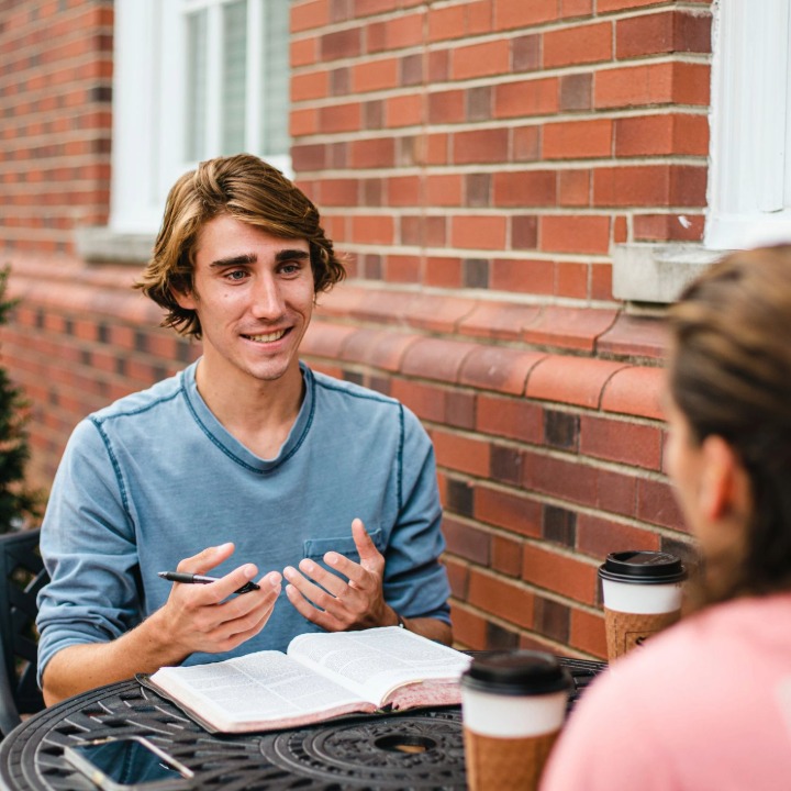 Two students sitting at patio table