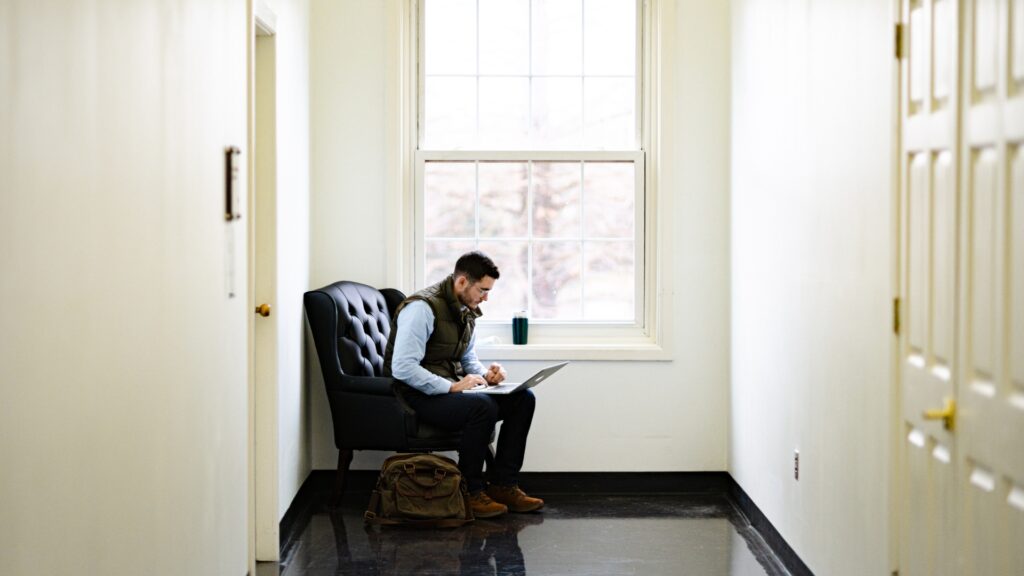 Student studying by window