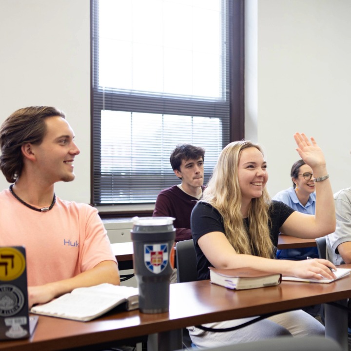 Female student raising hand in Boyce classroom