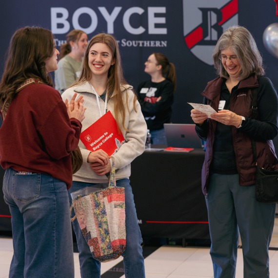 Student and parent asking questions at Boyce event