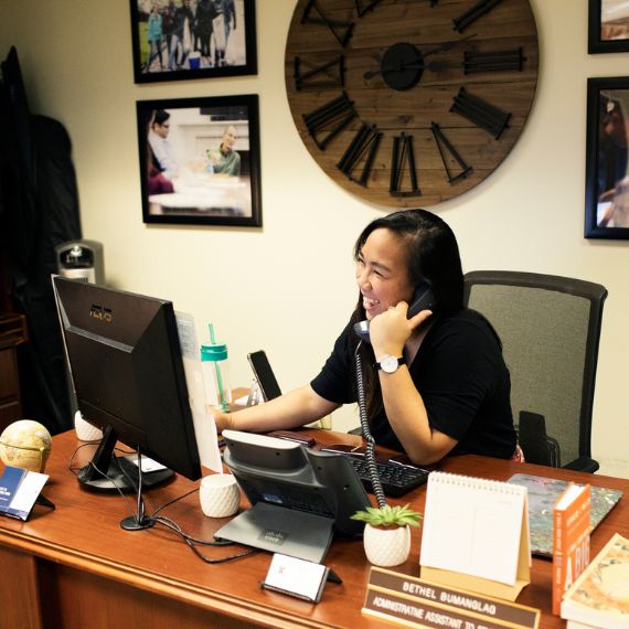 Woman using office phone