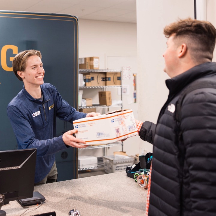 Mailing Service employee giving package