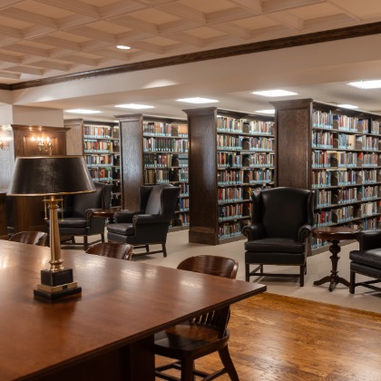 Library book stacks and reading table