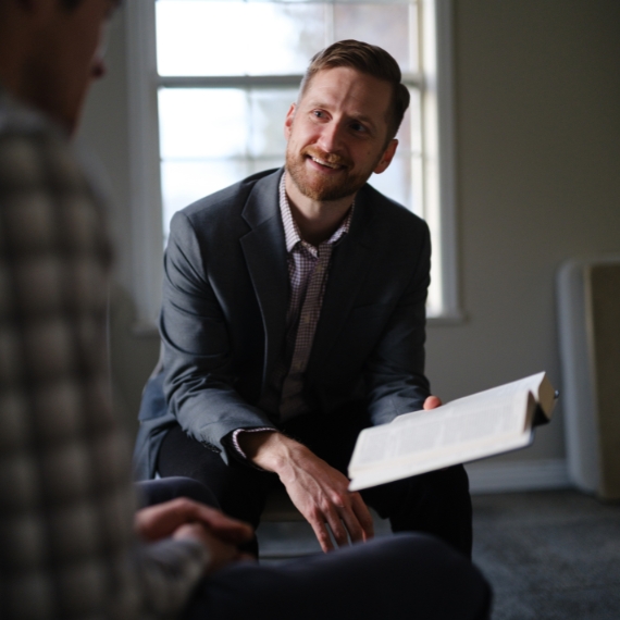 Timothy O'Day speaking with another man