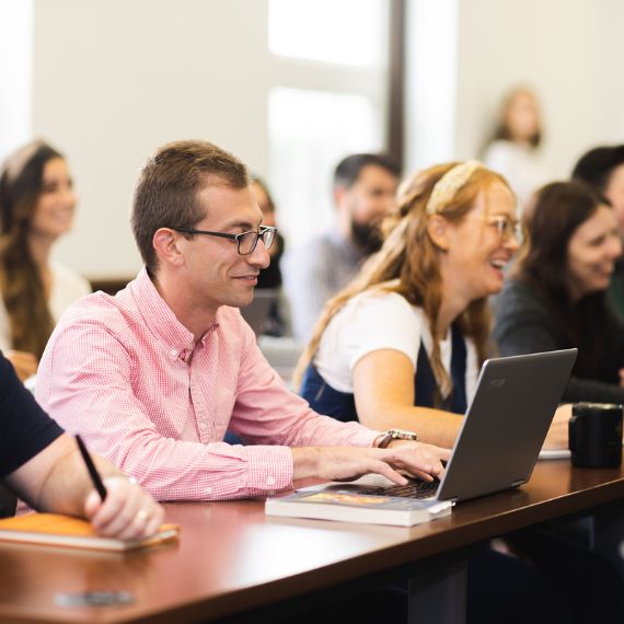 Student in class with laptop